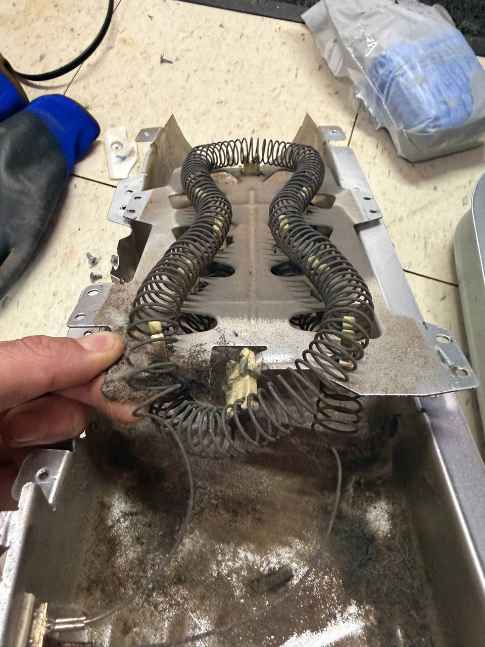 Failed dryer heating element removed during repair - Done Right Appliance Repair