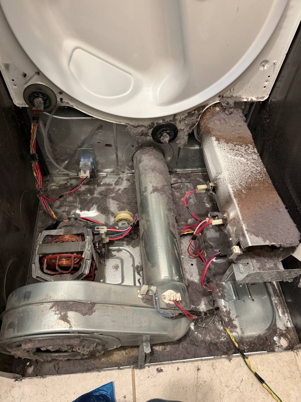 Dryer disassembled showing motor blower and heating components - Done Right Appliance Repair